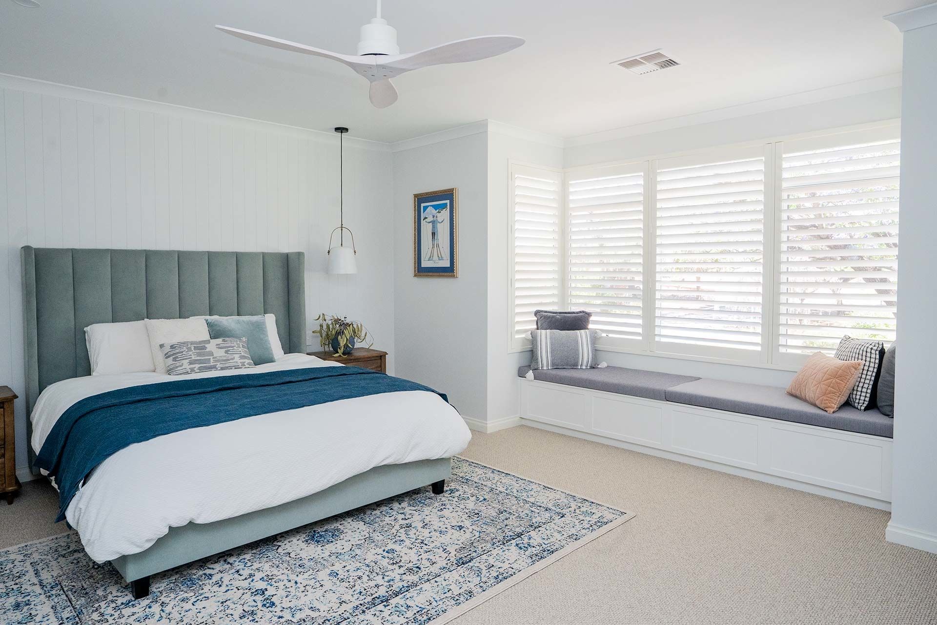 White Norman Brightwood shutters in a bright, airy bedroom