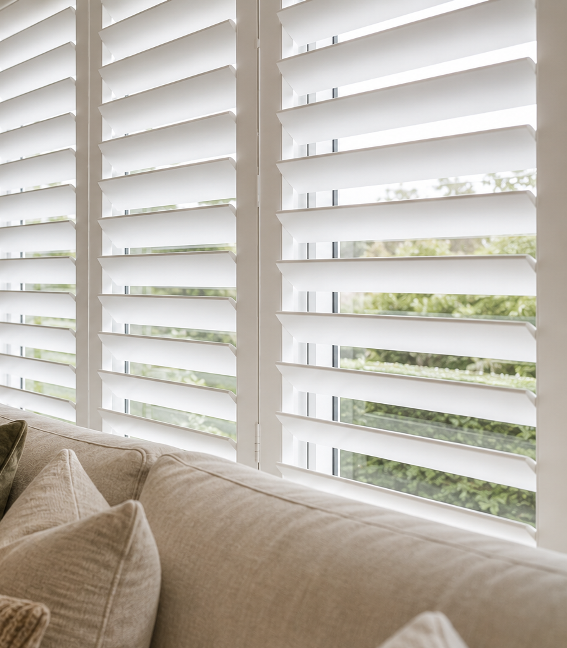 White Norman Woodlore plantation shutters in a bright Perth living room