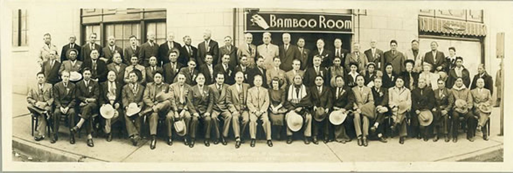 an old panoramic photograph of a group of well-dressed people