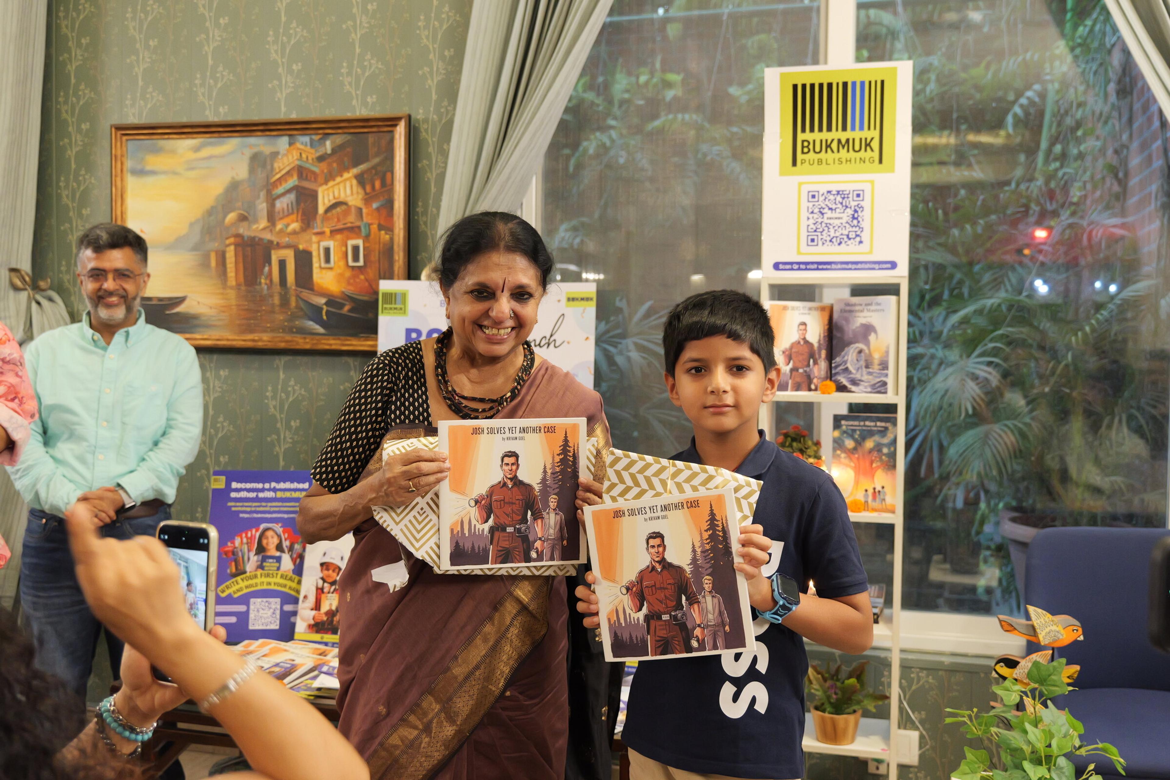 A young author with his book at our June book launch.