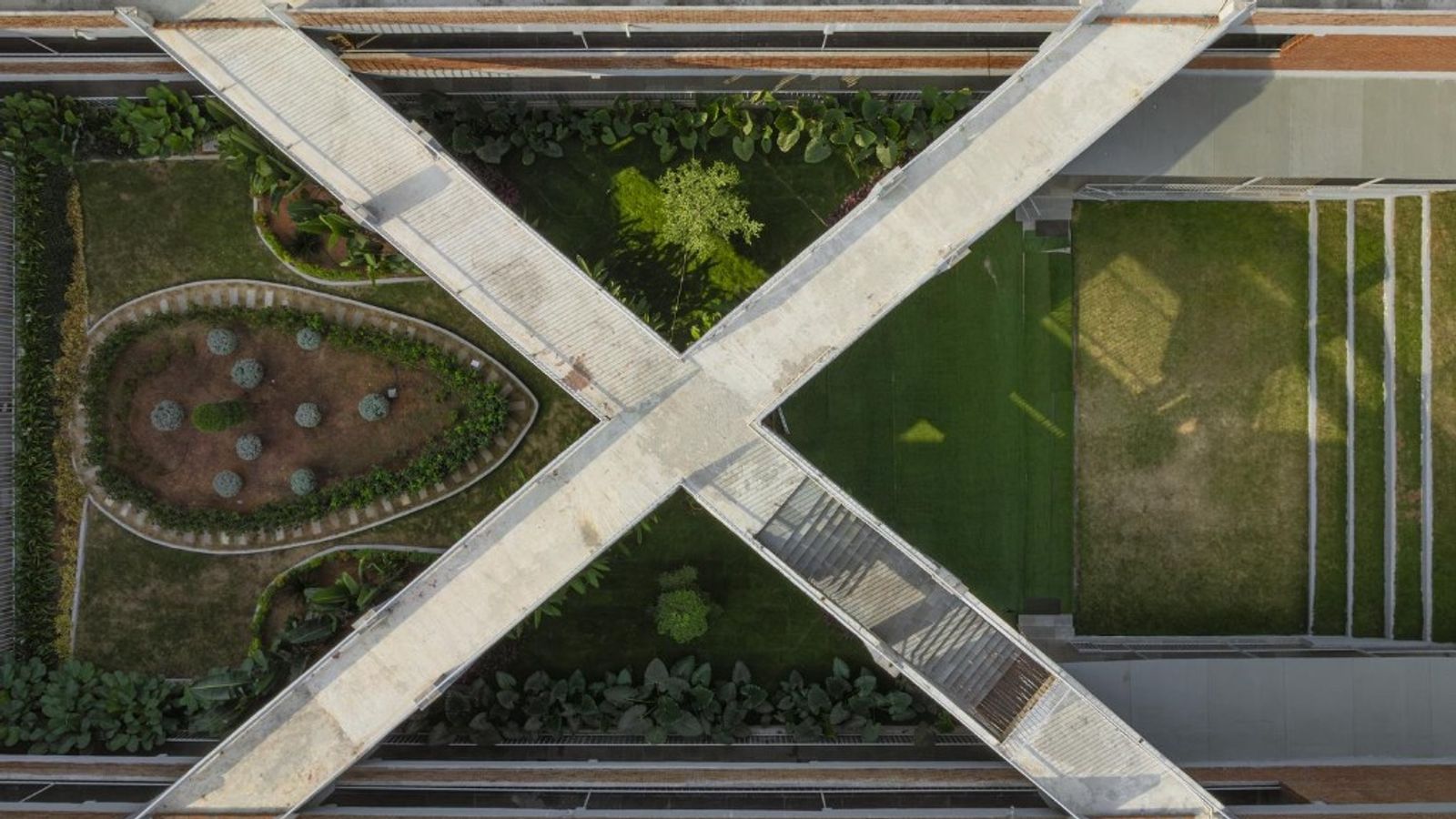Aerial view of intersecting walkways forming an X over a landscaped courtyard, symbolizing matching payments to invoices