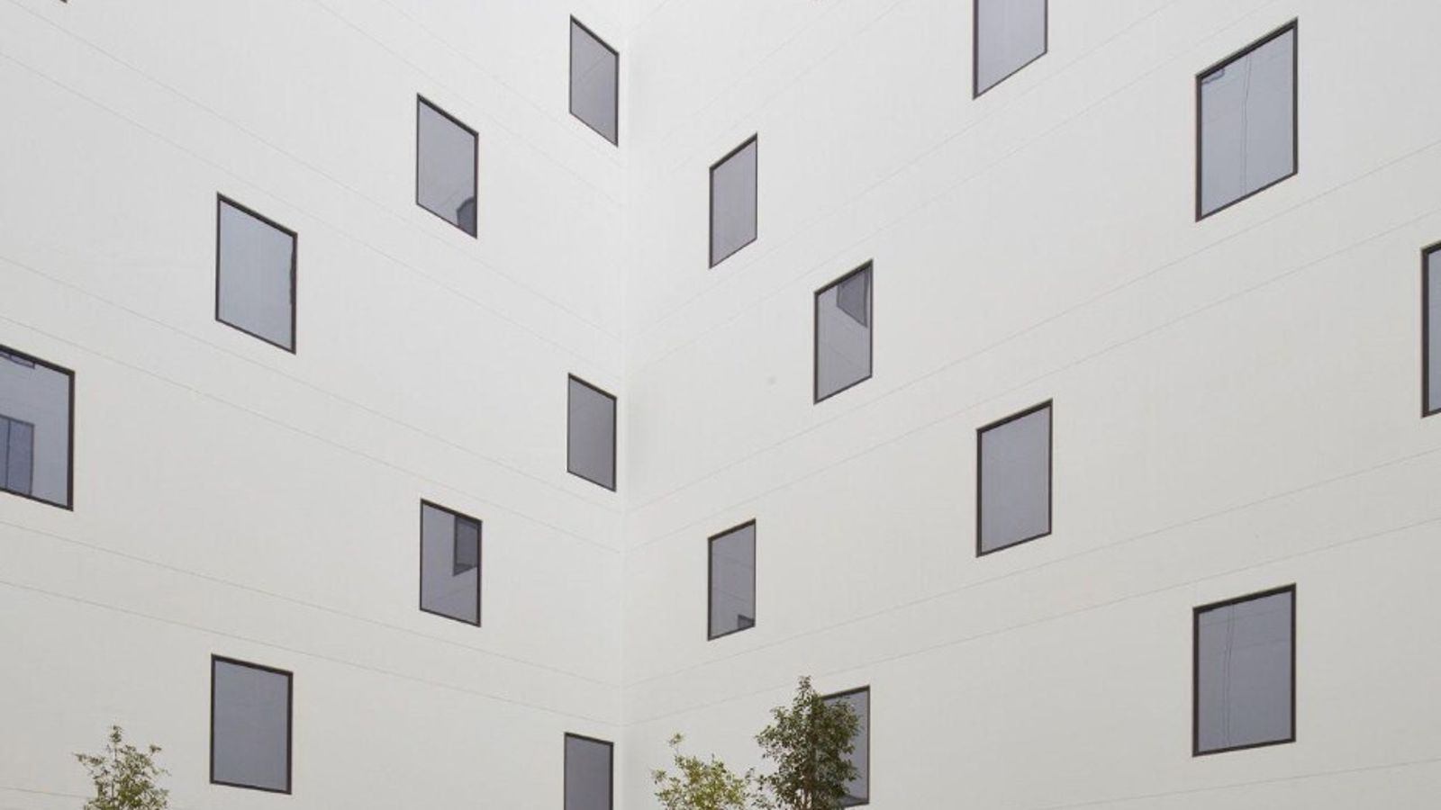 A minimal architectural courtyard with repeating geometric forms, suggesting structure and predictable, recurring billing