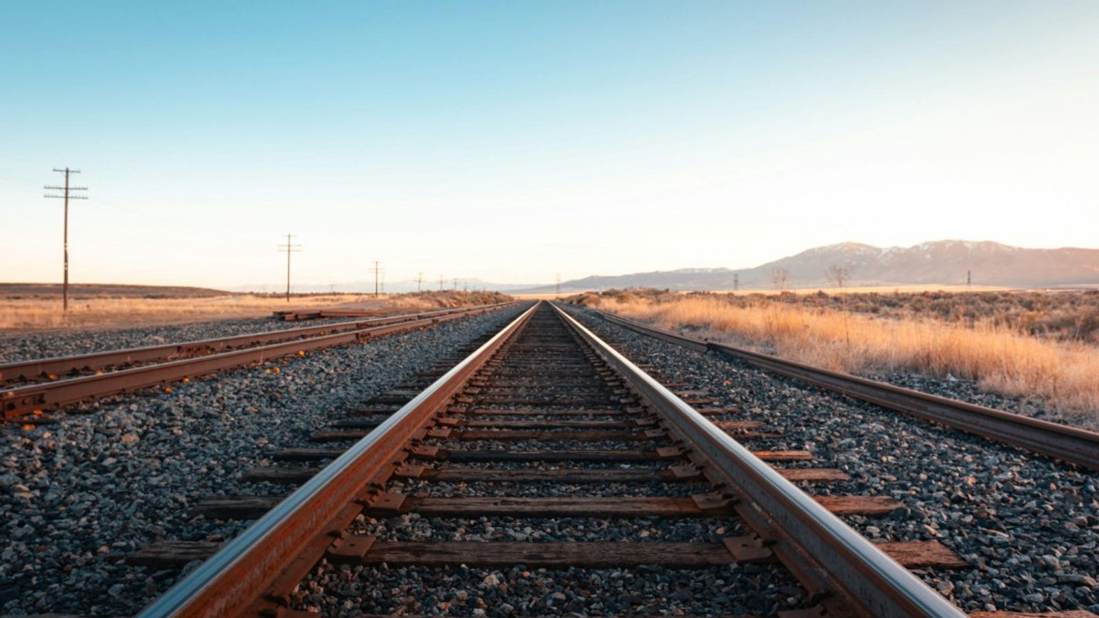 Railway tracks stretching toward the horizon, symbolizing an invoice's progression through its lifecycle