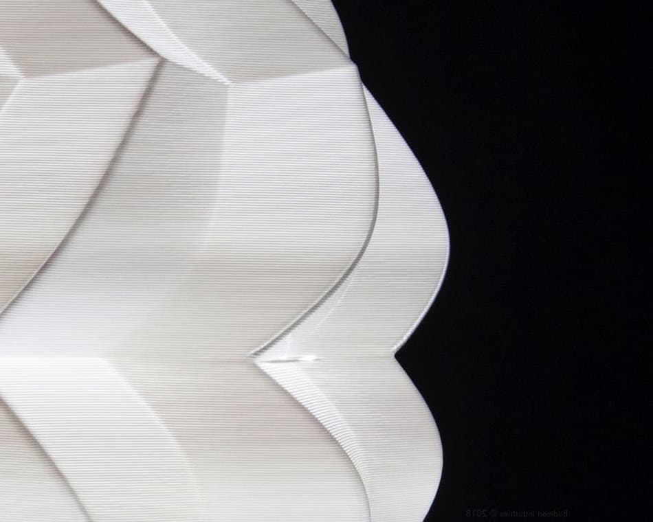 Close up image of stacked 3d printed layers illuminated
