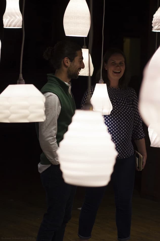 Installation showing wall of illuminated lamps