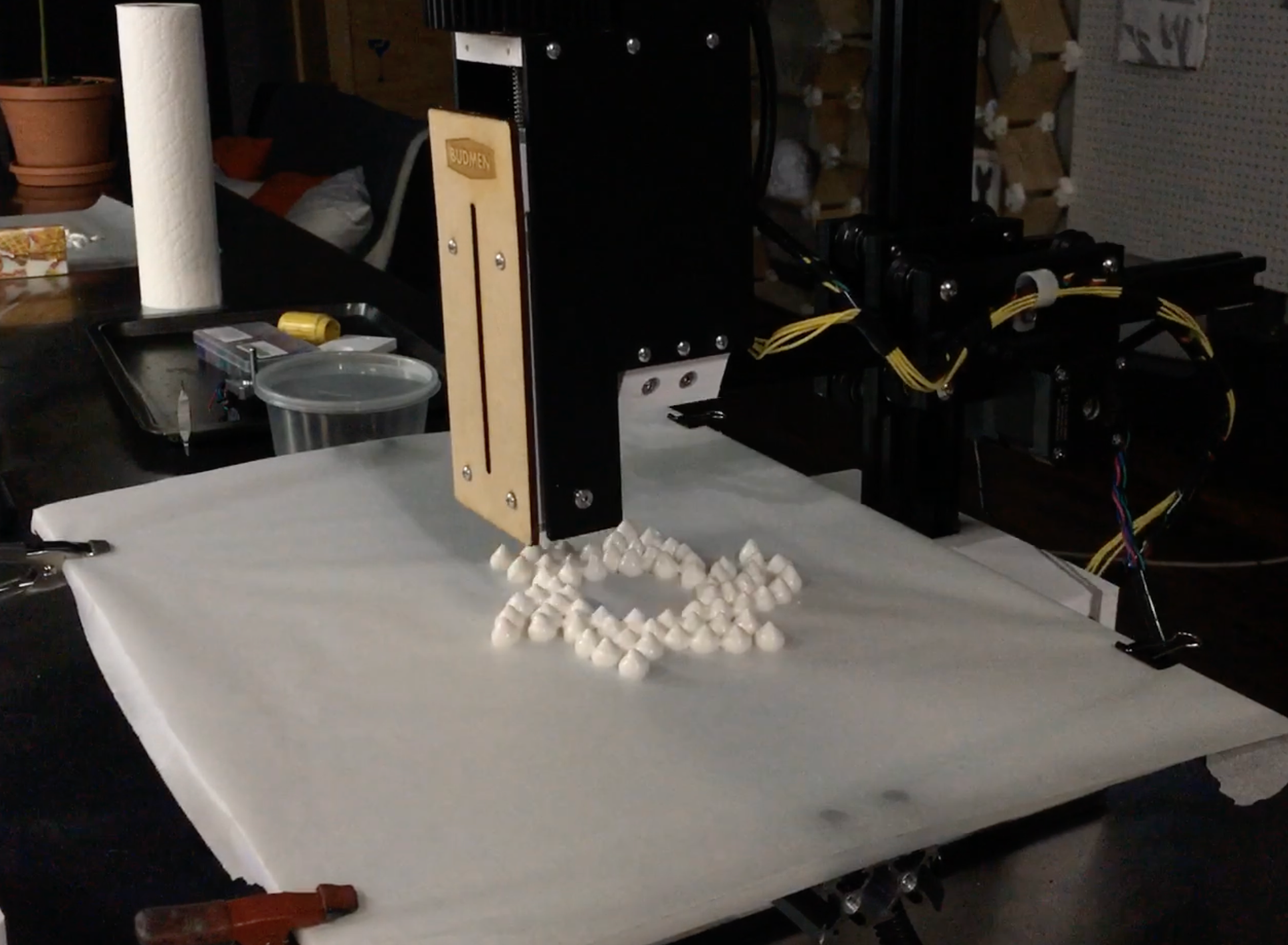 Close-up of printer creating Hershey Kiss-shaped dollops in rhythmic motion