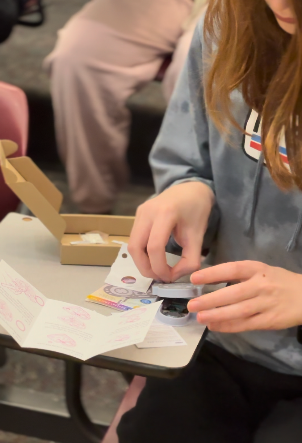 Student testing completed robot for first time showing wonder and surprise