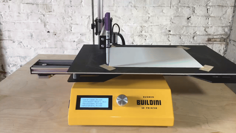 Placing a pen on the Buildini and using the machine to draw