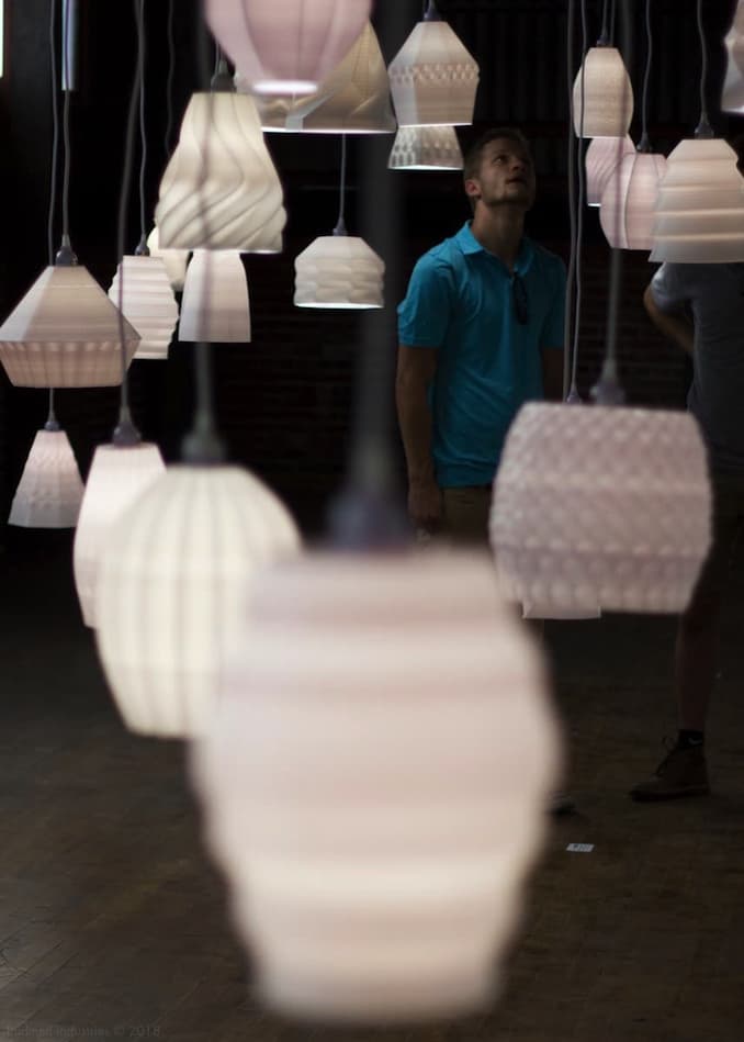 Installation photo showing person viewing lamps