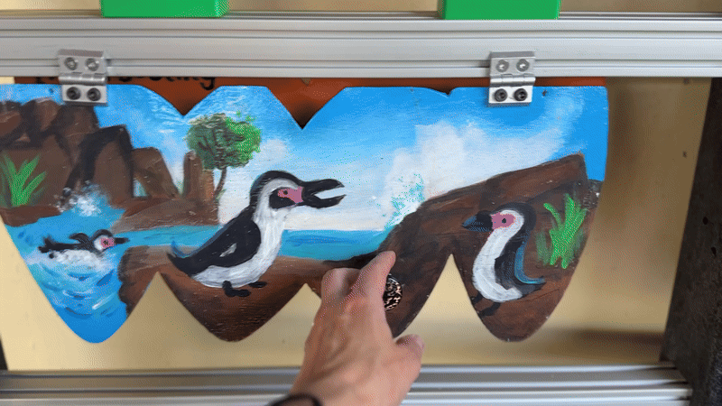 Lifting up the panel to reveal the answer