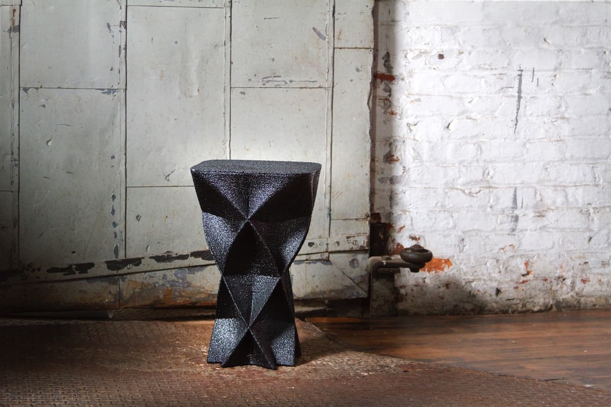 Scoria Stool with undulating water-inspired form