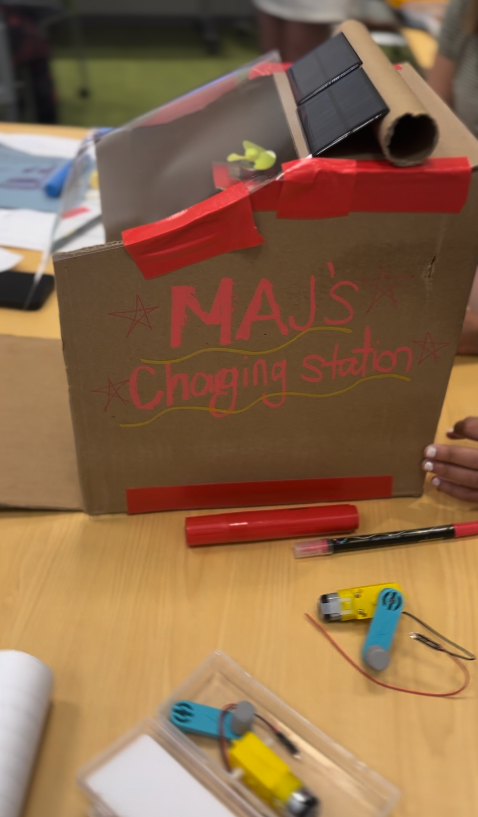 Close-up of student's power beacon with solar panels and hand crank dynamos.
