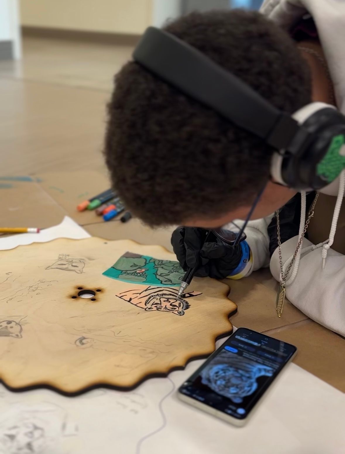 A student referencing their drawings for their Curious Critter Corner, each answering one of the most-asked questions at the zoo. 