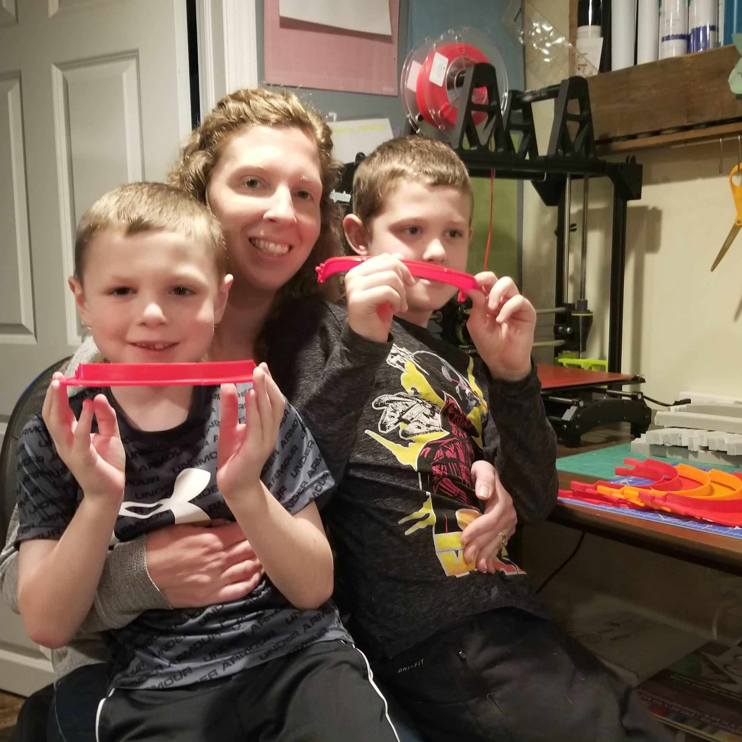 Katie and her sons helping her produce and assemble face shields.