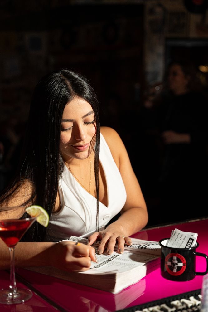 A guest picking a song from the songbook with a cocktail