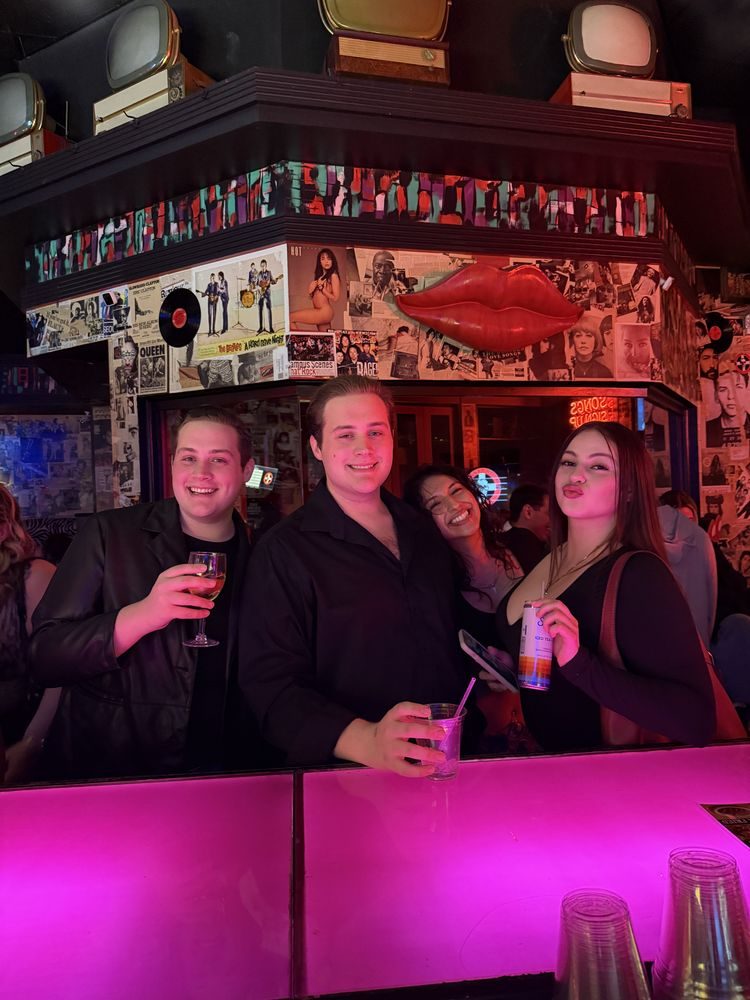 Group of friends with drinks at the bar