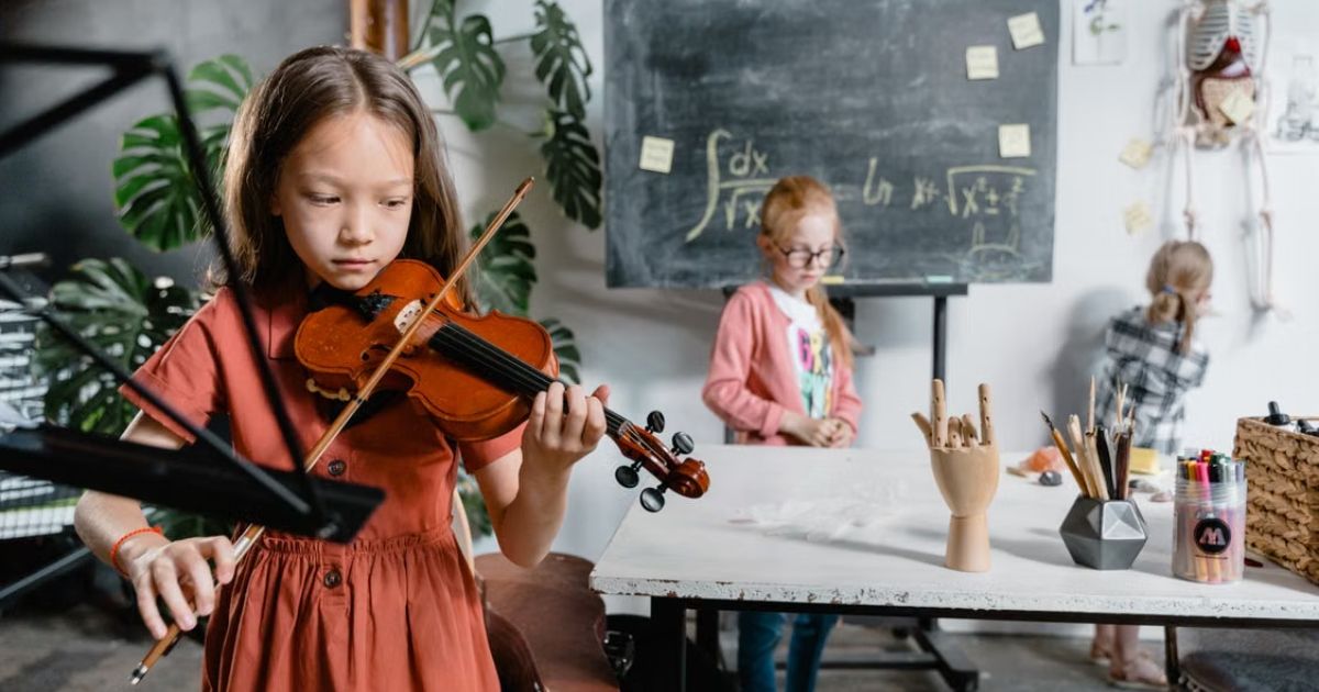 UK private school students playing violin and instruments during a music rehearsal