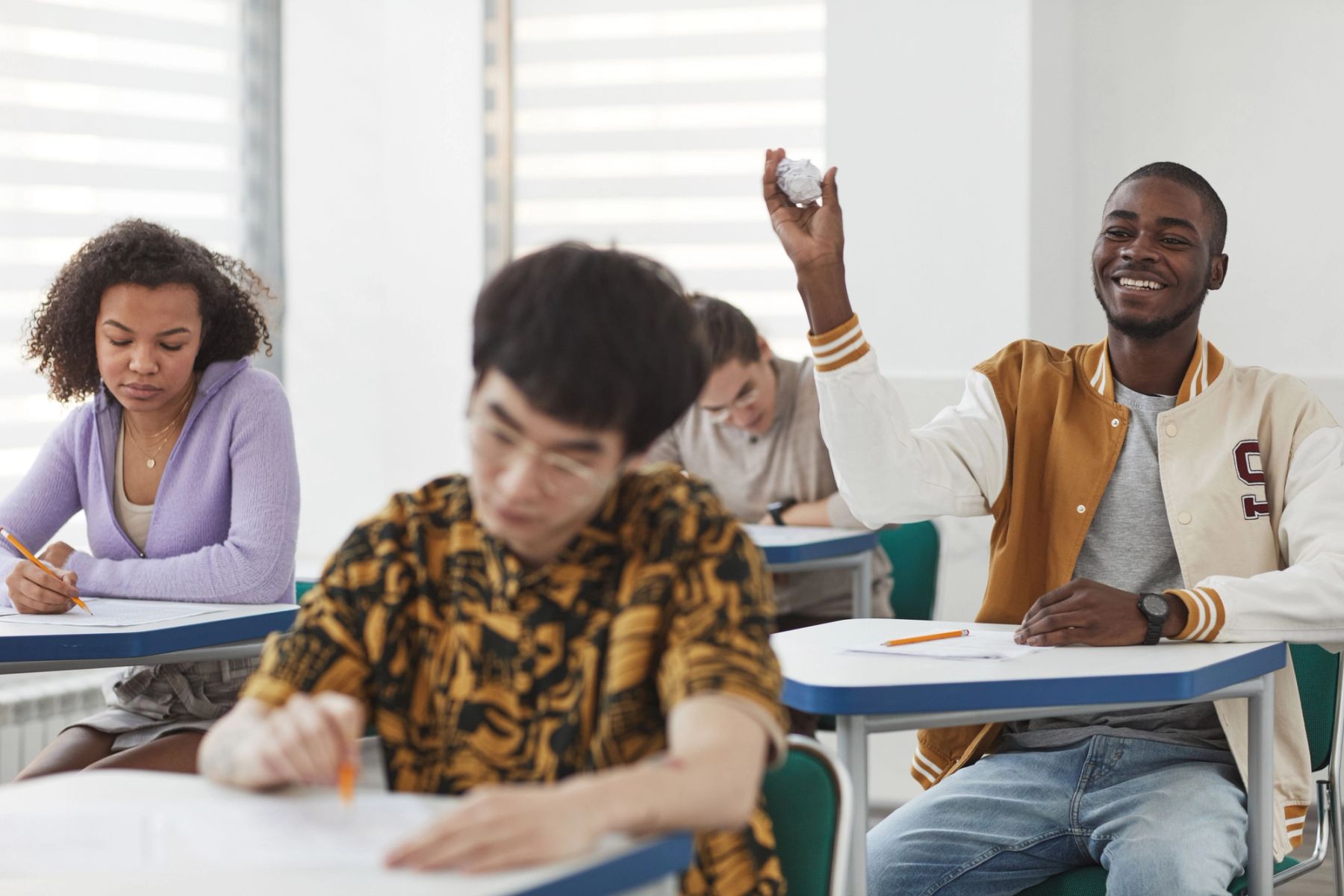 UK secondary school students participating attentively in a modern classroom setting