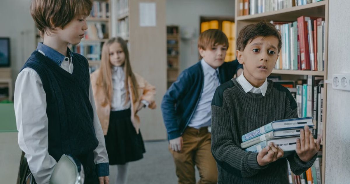 UK private school students in uniforms studying together in a traditional school library