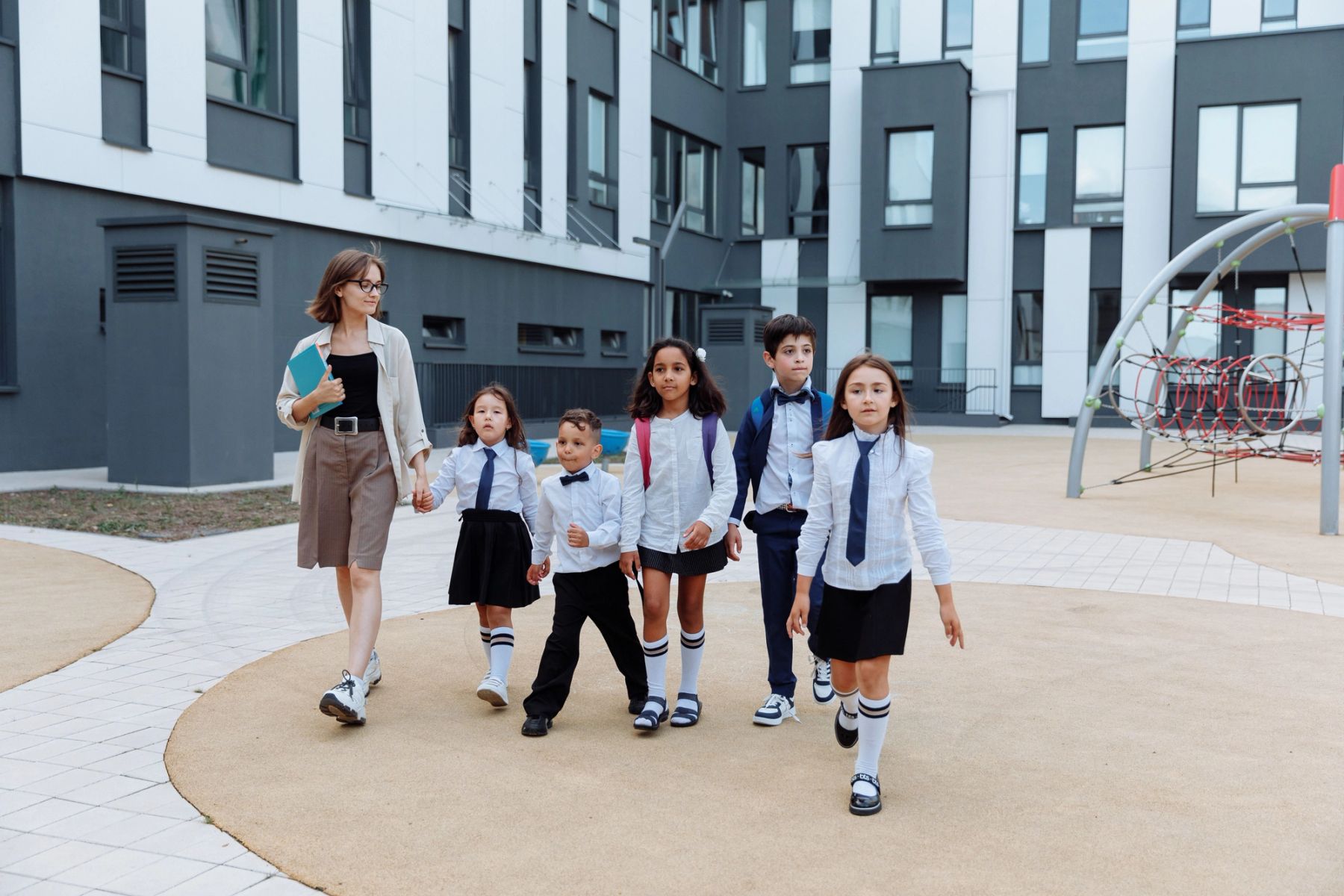 International boarding school students walking across a historic UK independent school campus