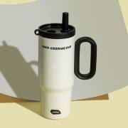 White insulated tumbler with black handle and straw lid