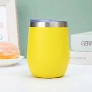 Yellow 12oz insulated tumbler in a cafe setting