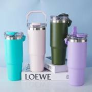 Travel tumbler shown with handle, straw spout, and direct-sip opening