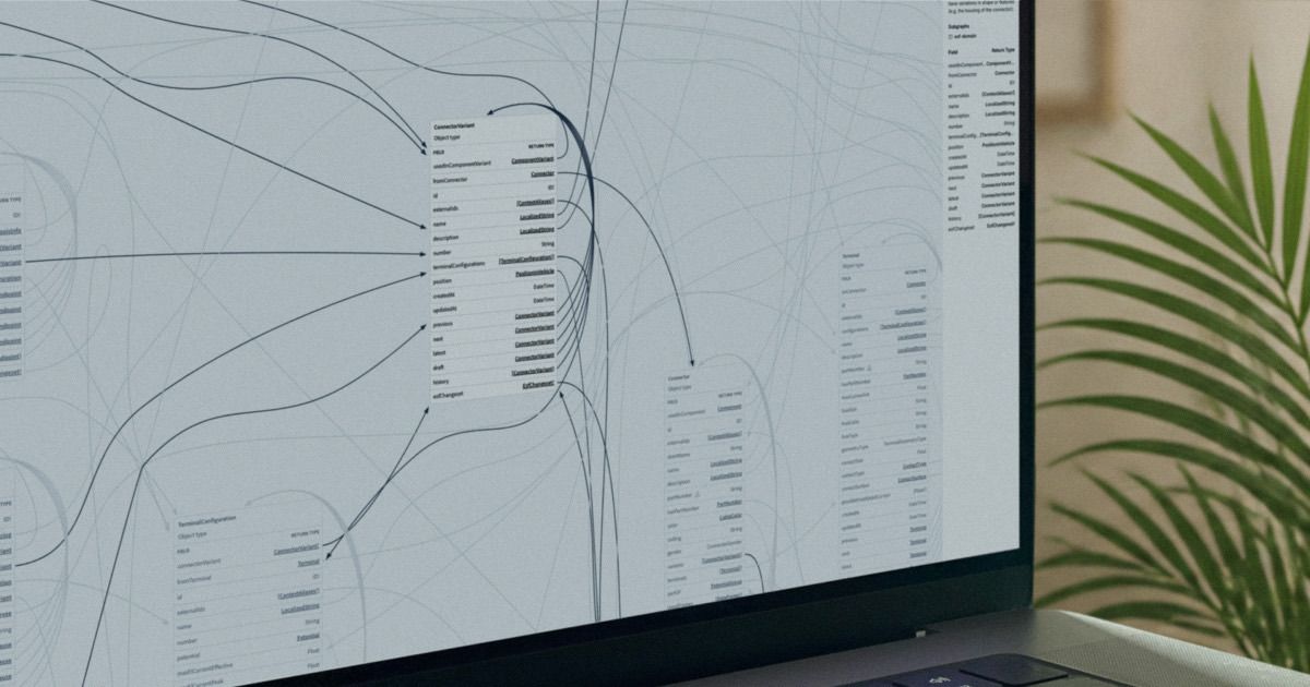 A laptop screen showing an engineering knowledge graph: component and variant schema tables connected by curved relationship edges