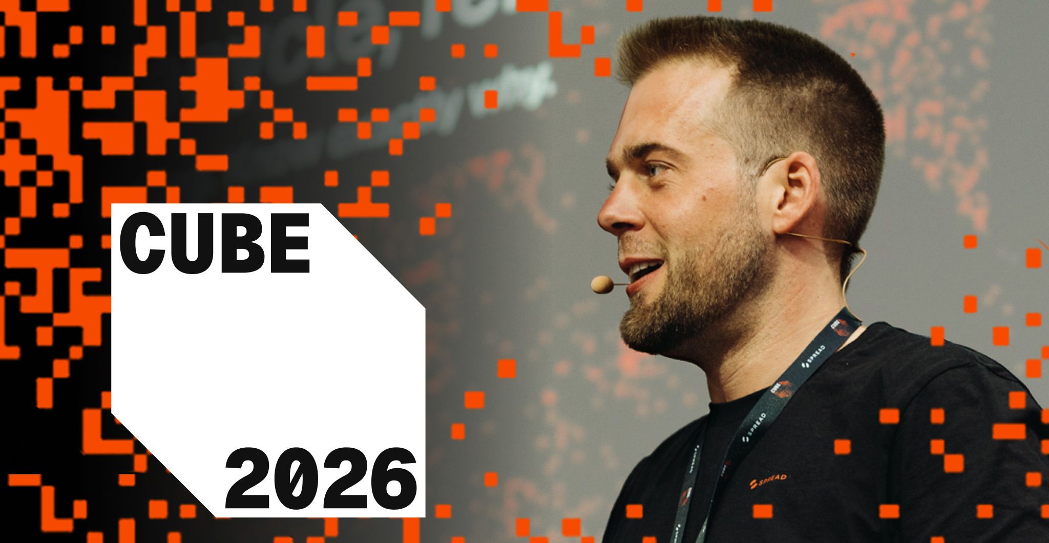 Philipp Noll speaking at CUBE 2026, with the CUBE 2026 pixel branding