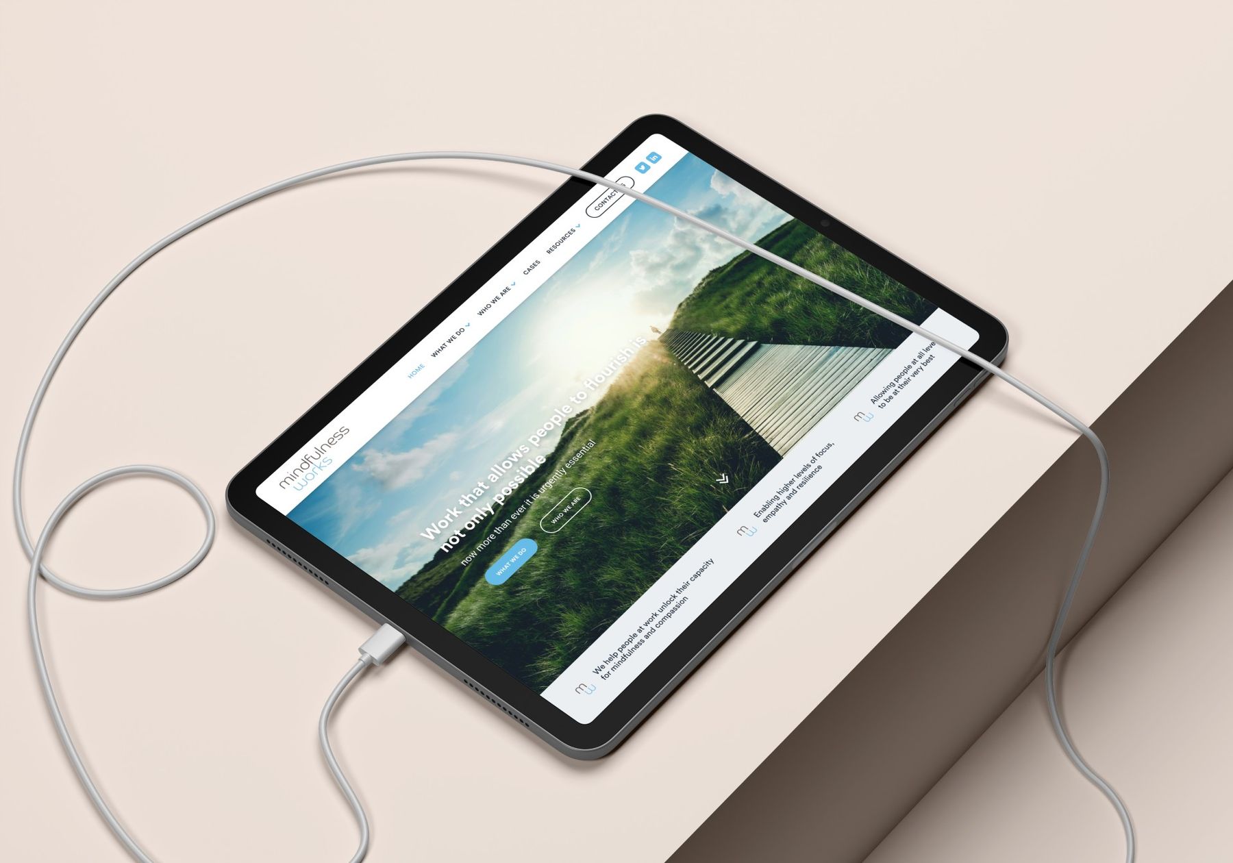 The Mindfulness Works website on a tablet resting on a desk