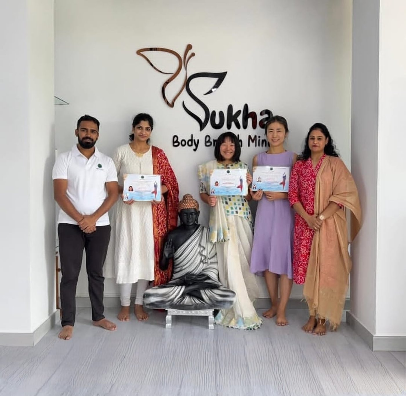 Graduates celebrating certification at Sukha