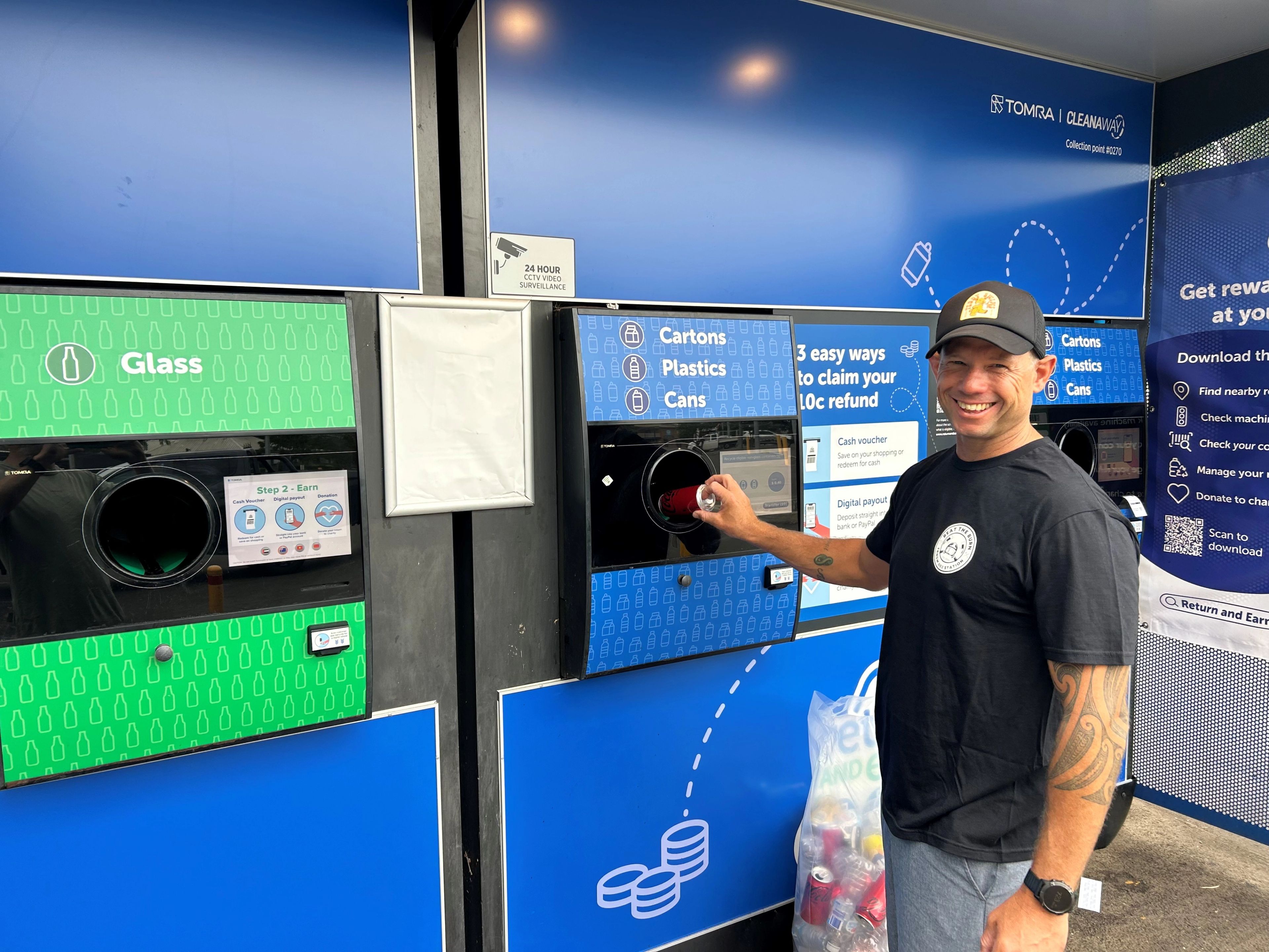 Firefighter standing beside the return and earn machine