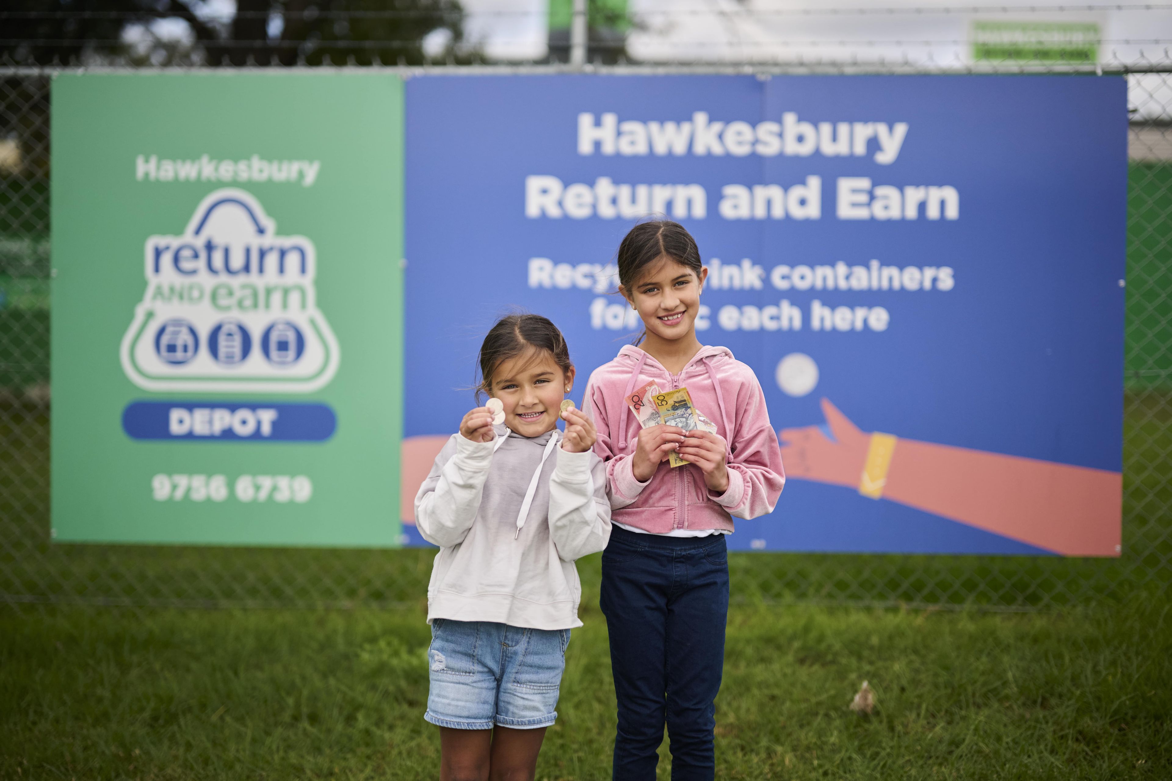 two kids holding money infront of return and earn banner