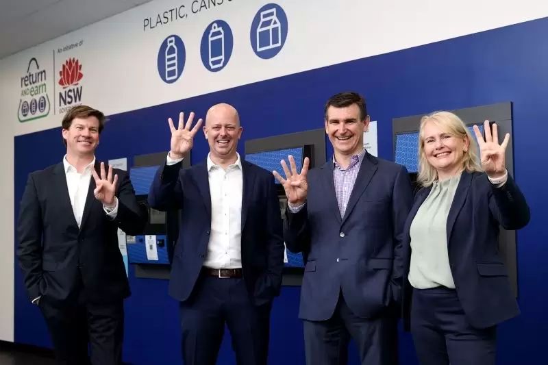 4 people holding up the number 4 on these hands standing together