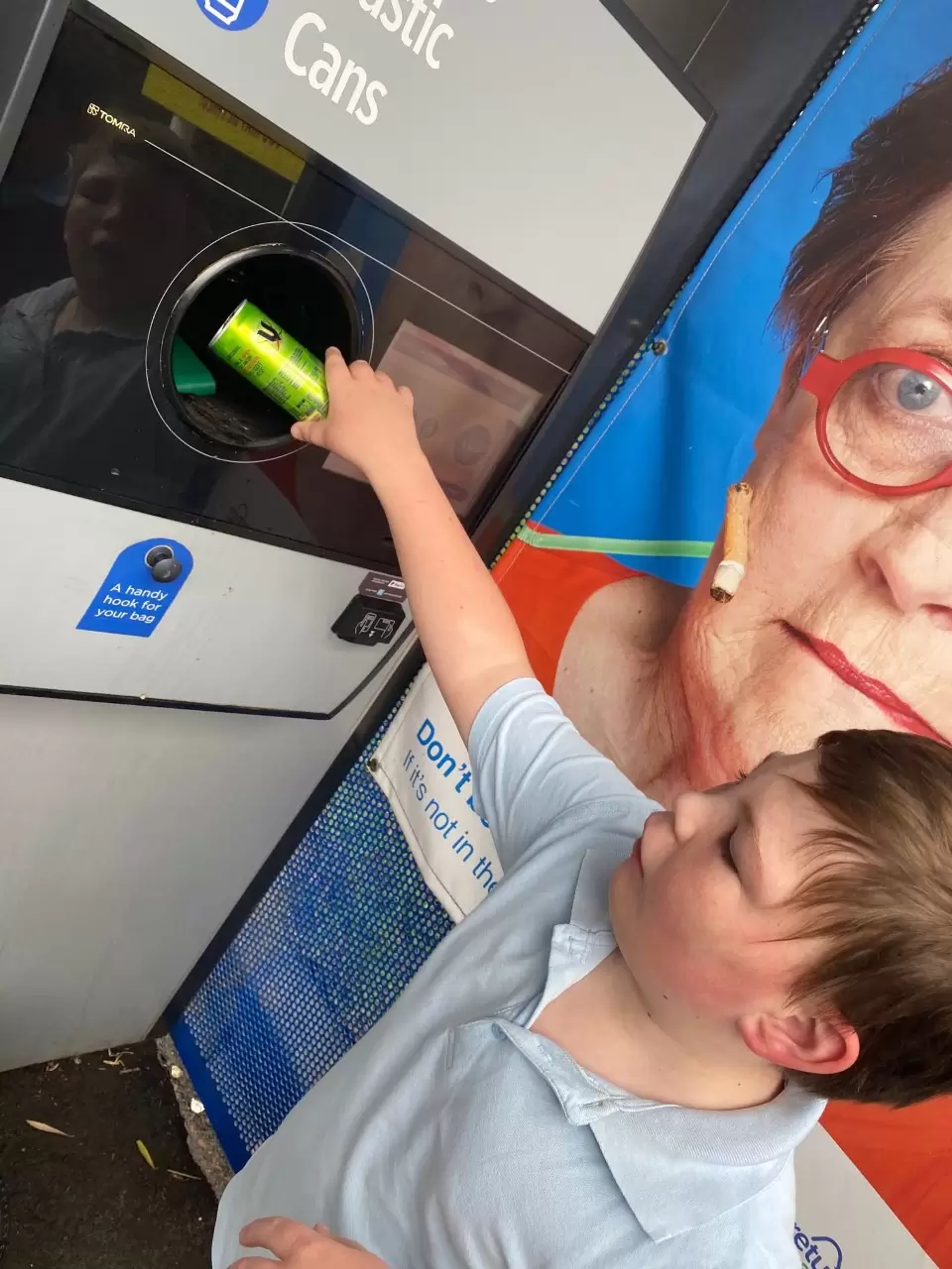 Kid using return and earn machine