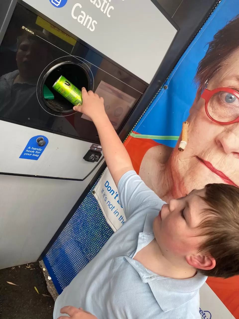 Kid using return and earn machine