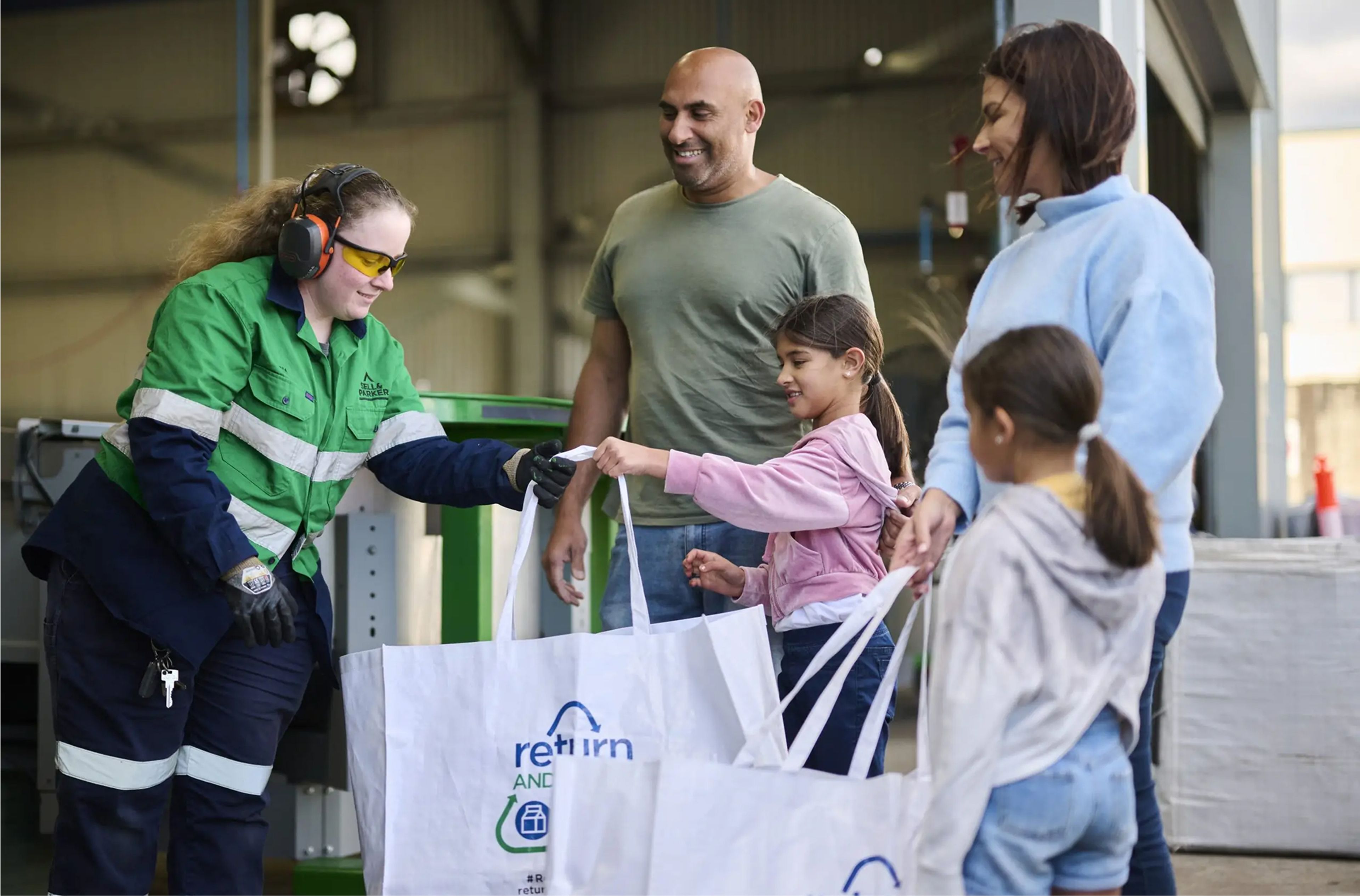 A family returning containers at a depot