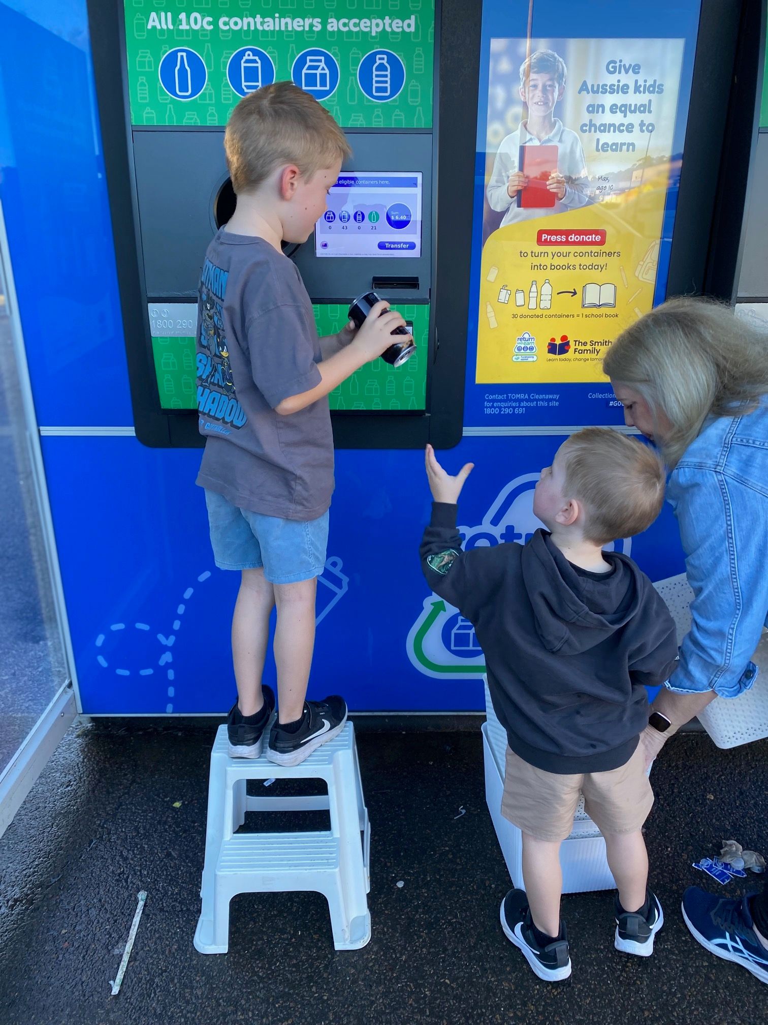 children and grandma returning containers into a machine 