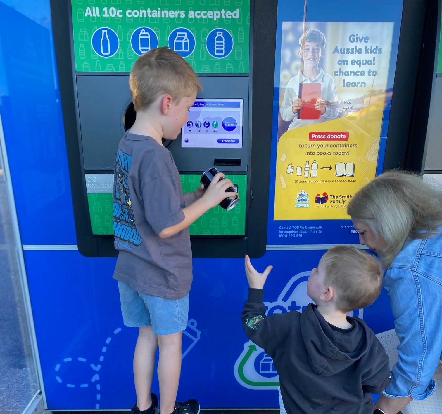 children and grandma returning containers into a machine