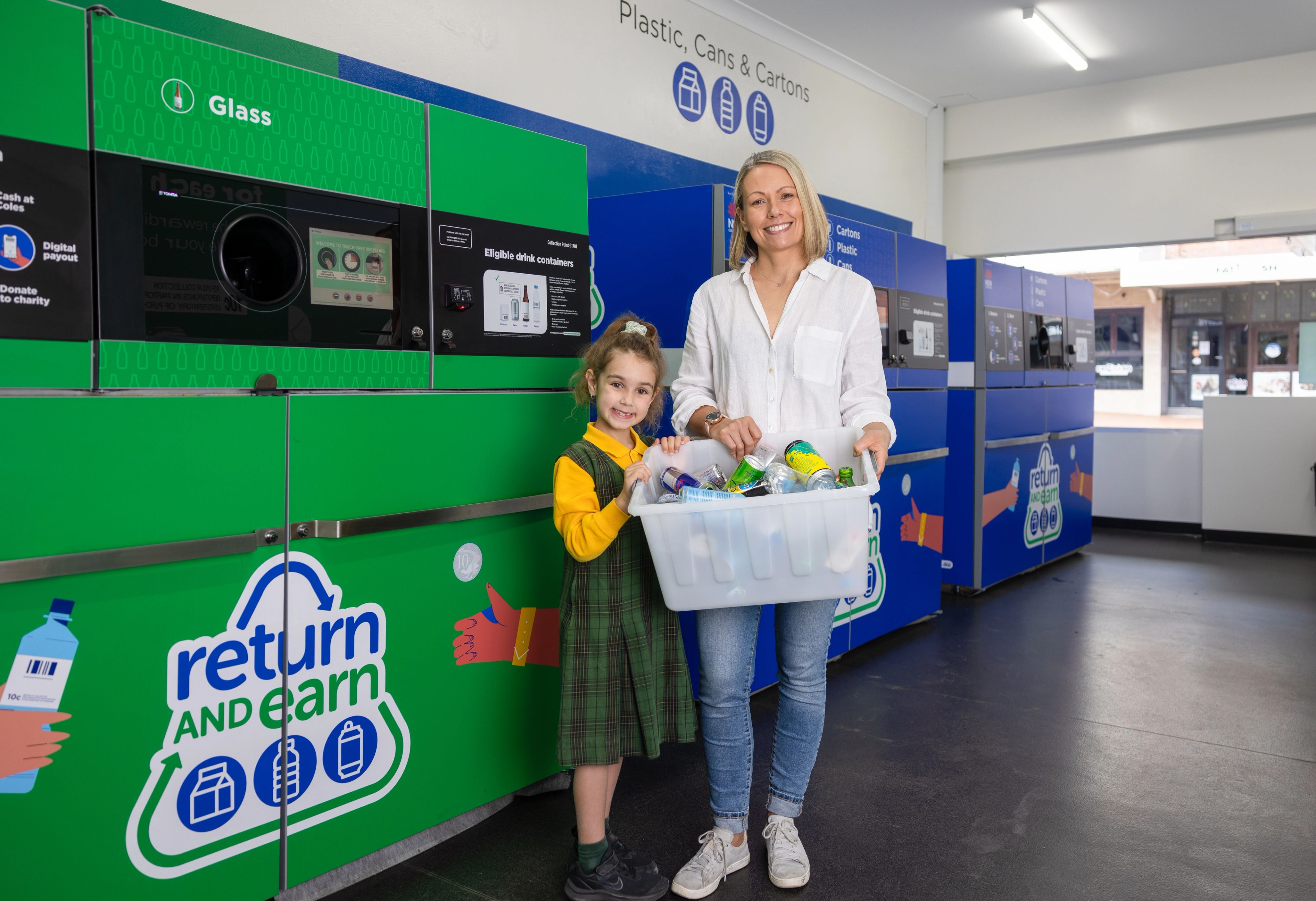 A mum and daughter visiting a Return and Earn Centre to return drink containers before school. 
