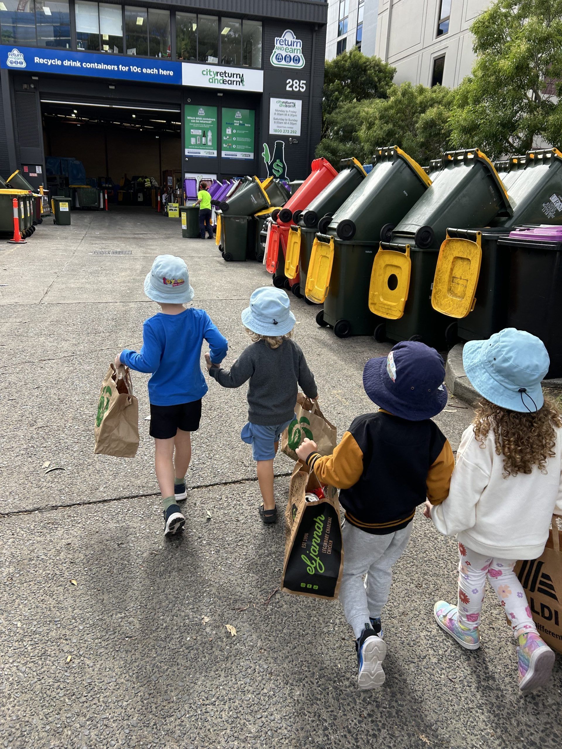Children walk to a return and earn depot