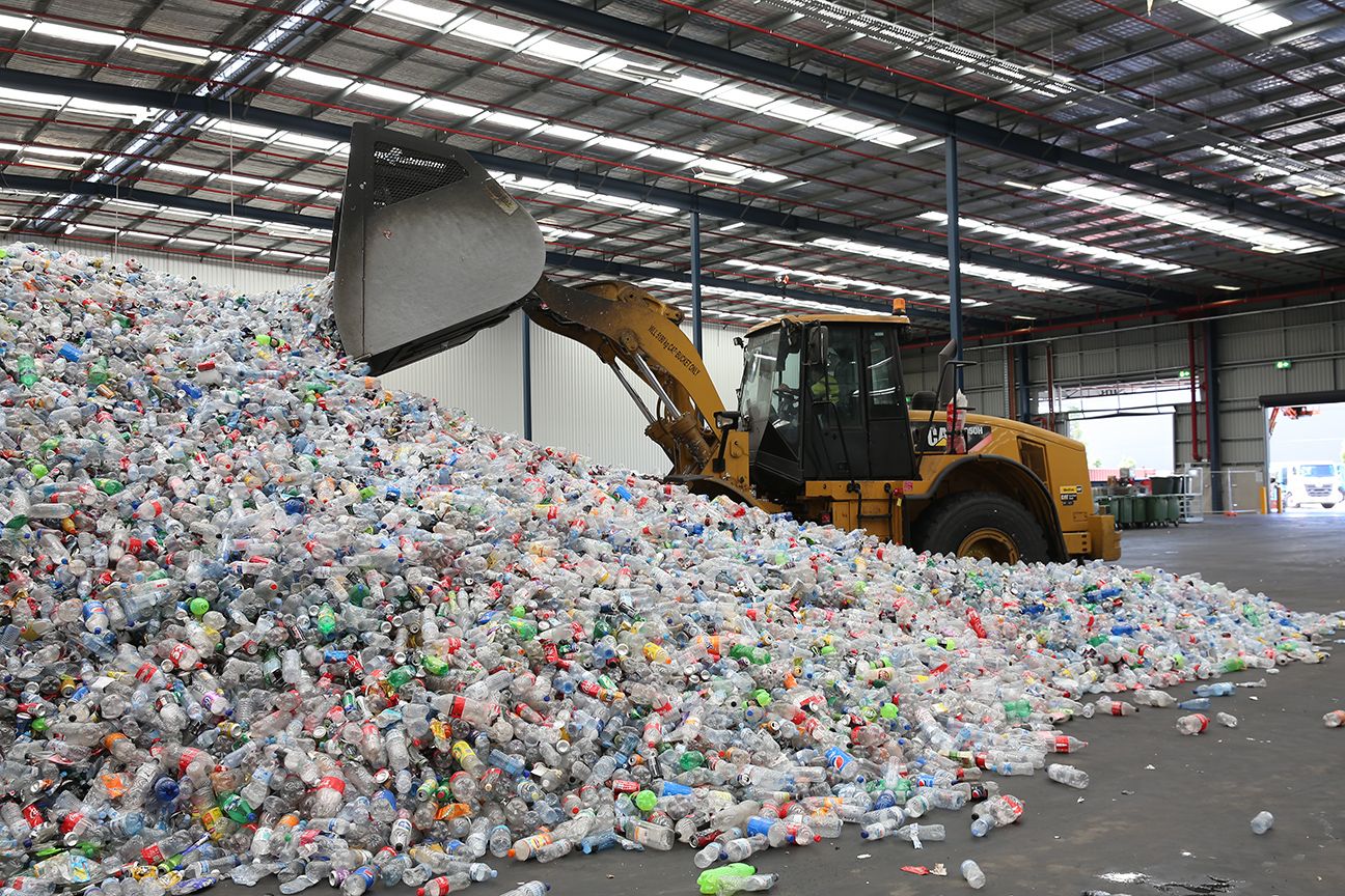 Cans and bottles being recycled with return and earn