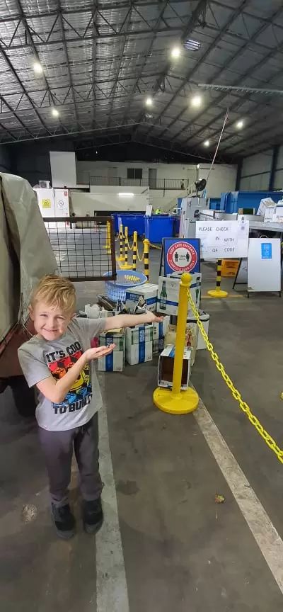 Eight year old at a return and earn station