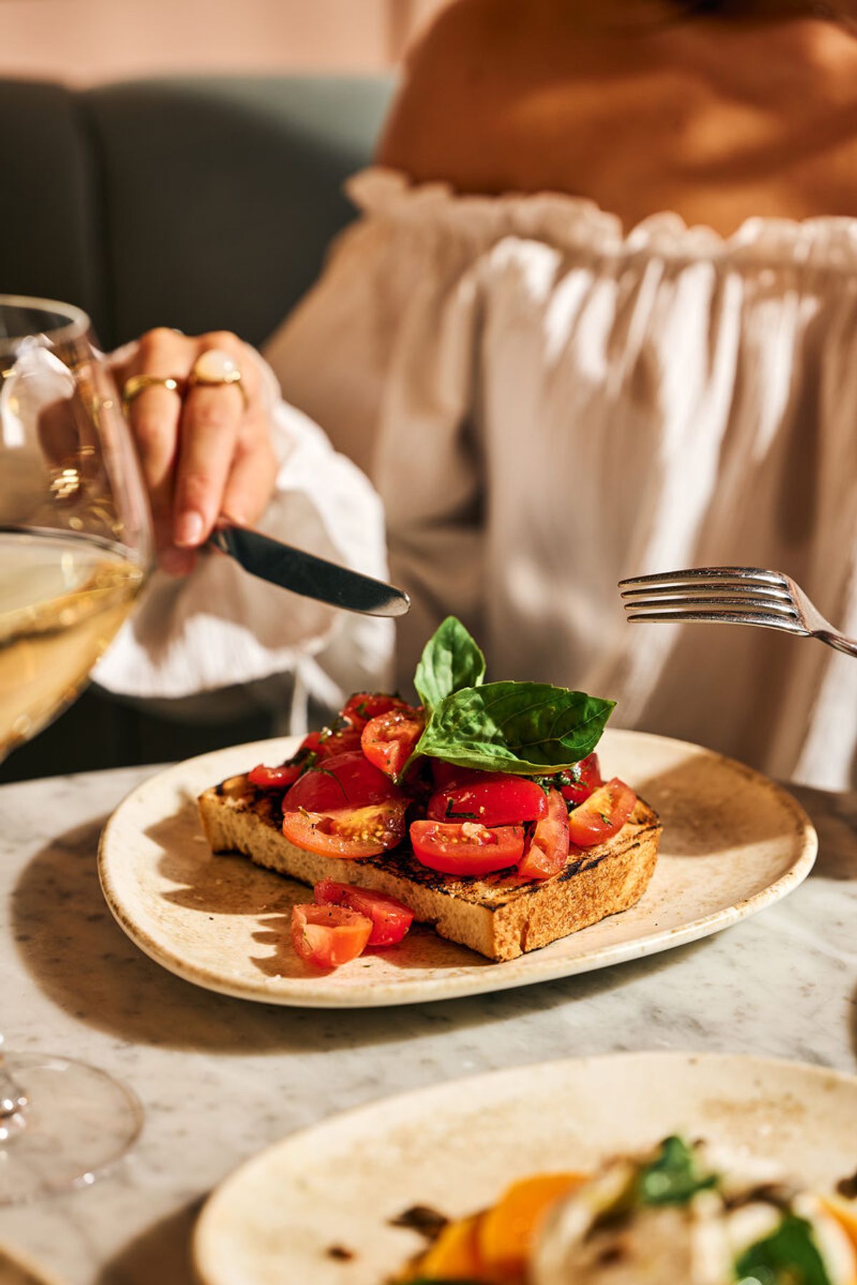 Tomato and basil bruschetta served with a glass of white wine