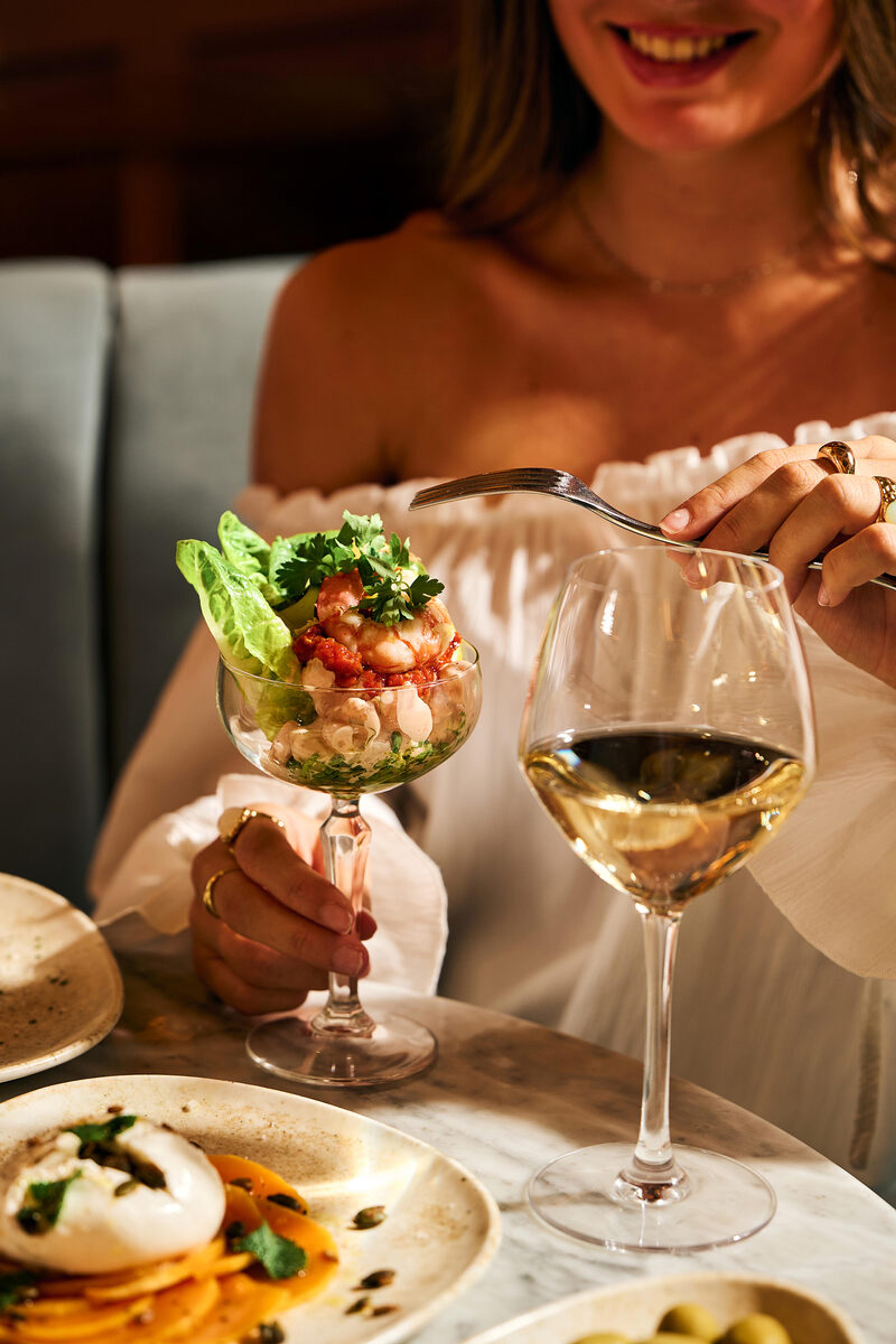 A Piccolino dish served with a glass of wine