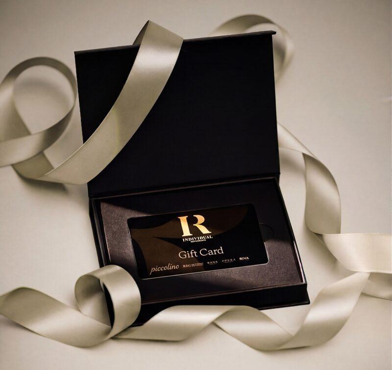 A Piccolino gift card in a black presentation box with ribbon