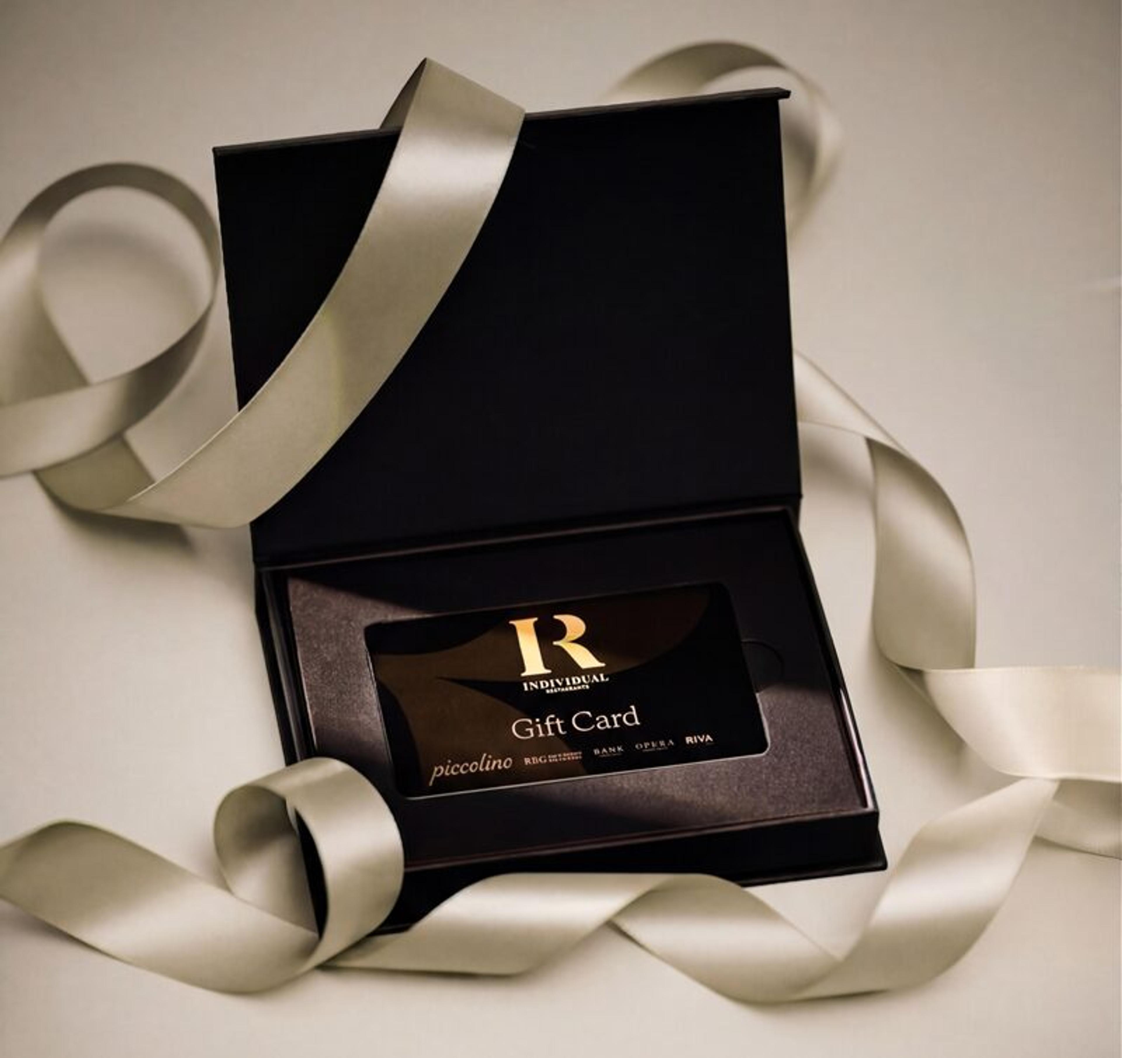 A Piccolino gift card in a black presentation box with ribbon