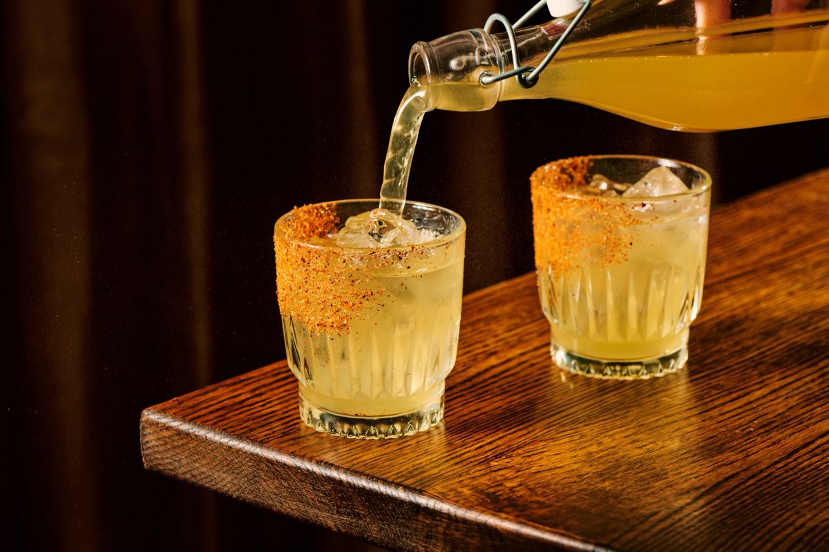Two spicy margaritas being poured