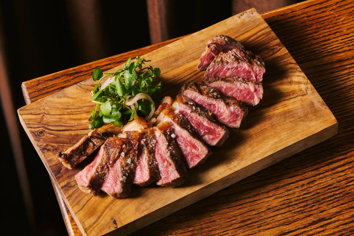 Medium rare steak on a serving board