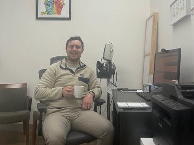 Community Paramedic with a cup of tea at a desk